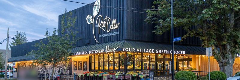 The Root Cellar green grocer at Cook and Oxford streets, in Cook Street Village, at dusk