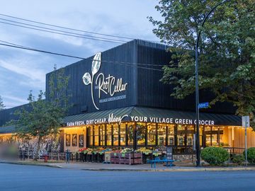 The Root Cellar green grocer at Cook and Oxford streets, in Cook Street Village, at dusk