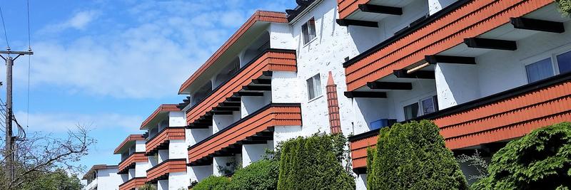 Low-rise apartment building with red balconies on a Fairfield street