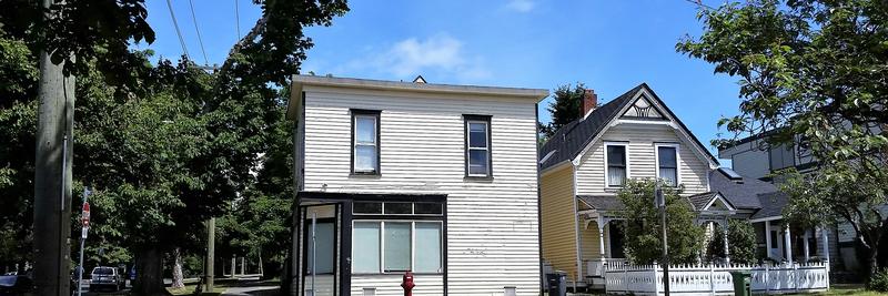 Older wooden houses under big street trees in Fairfield